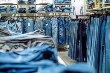 Jeans store in a shopping center. Denim sales. Blue pants. Shopping for women.