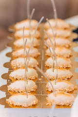 exquisite dessert with nuts on a gilded stand on wedding recepti