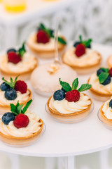 closeup of sand dough baskets with cream and berries. wedding pa