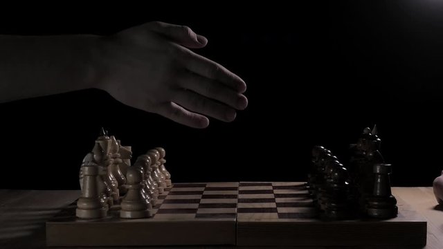 timelapse of a two-person chess game with a motion blur. at the end &mdash; a gesture of a good game