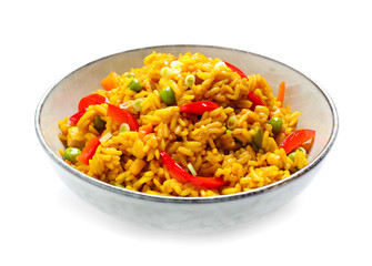 Delicious rice pilaf with vegetables isolated on white