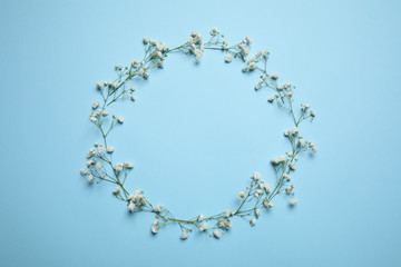 Frame made of beautiful gypsophila on light blue background, flat lay with space for text. Floral composition