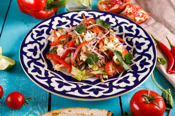 Fresh salad with beef, herbs and red pepper.