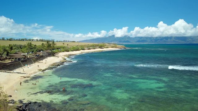 Ho'okipa Beach Park in Maui Hawaii, renowned windsurfing and surf site for wind, big waves and big Turtles drying on sand. Snorkeling paradise for coral reefs. Gimbal panning cinematic ProRes 422