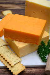 Leicestershire cheese or red leicester and mature cheddar, variety of British hard cheeses made from cow milk