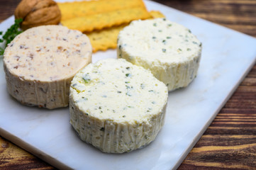 Spread cream cheese with herbs, garlic, chives and spices close up