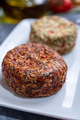 Different french soft goat cheeses made with spices and herbs