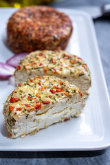 Different french soft goat cheeses made with spices and herbs