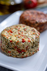 Different french soft goat cheeses made with spices and herbs