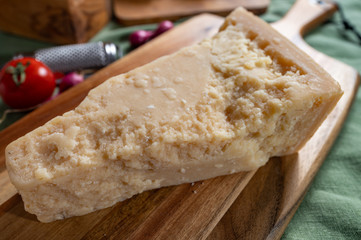 One piece of authentic Parmigiano-Reggiano or Parmesan Italian hard, granular cheese