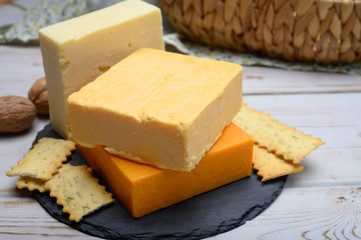 Leicestershire cheese or red leicester and mature cheddar, variety of British hard cheeses made from cow milk