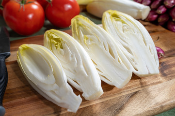 Fresh Belgian endive or chicory bitter salad ready to cook or eat