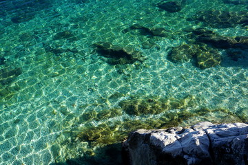 Turquoise sea water, clear and transparent water in the shallow with sun ray reflection on the surface