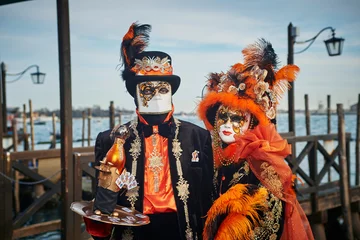 Fototapete Karneval The anonimous person in the bright traditional fashionable Venice carnival costume with the mask  © Antonio
