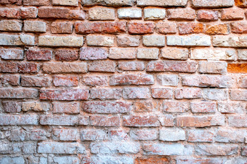 Obraz premium wall of destroyed bricks. grunge background for design, closeup. cracked wall