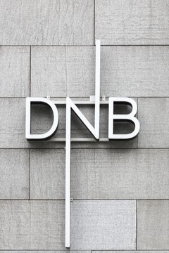 Oslo, Norway - August 27, 2018: DNB logo on a wall. DNB is Norway's largest financial services group