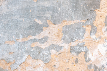 old plaster with cracks. environmental impact on buildings. cement-gypsum plaster. Coarse structure background. Grunge uneven surface of old street stone.