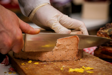 Cutting aged cheese in grocery shop