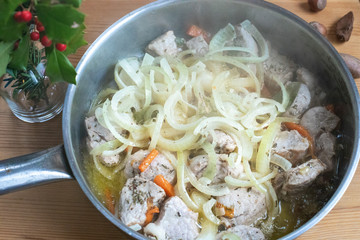 Pieces of chopped meat are fried in a pan