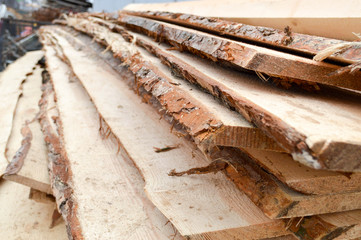 Lots of long wooden natural planed boards and sticks at a sawmill. The background. Texture....