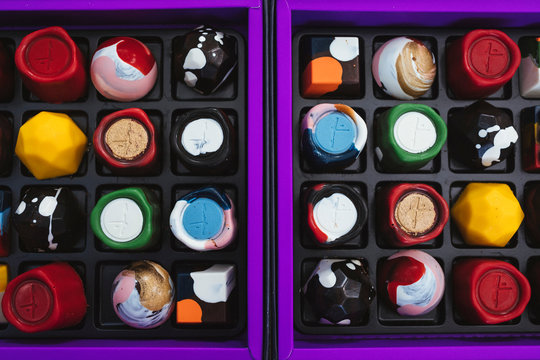 High angle close up of selection of bonbons in a purple and black box.,Singapore