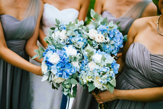 High angle view of bride and bridesmaids holding blue and white flower bouquets.,Koh Samui