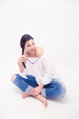  Brunette woman model with blue jeans sitting on white background