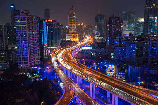 Elevated view of stacked road junction & Shanghai skyline at dusk, Shanghai, China,Shanghai