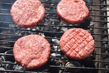 cooking burgers on the grill in nature