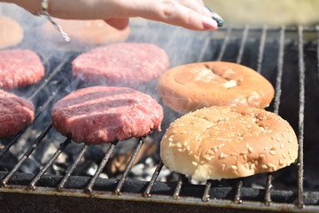 cooking burgers on the grill in nature