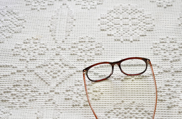 Eye Glasses on a White Textured Blanket