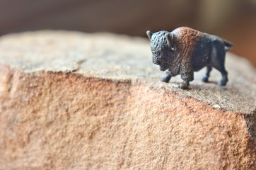 Miniature Toy Buffalo / Bison Standing on a Rock