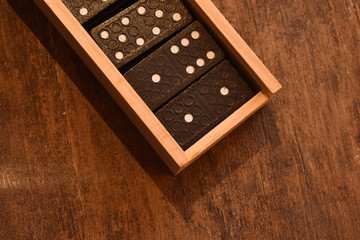 wooden case with dominoes