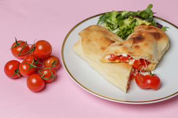 Italian appetizer bread stuffed with paprika and cheese,  simple savory stuffed bread on a plate