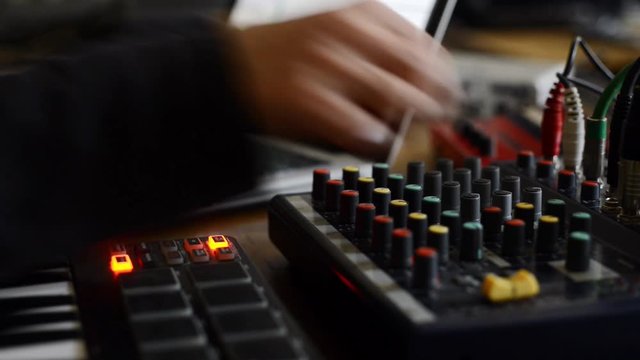 electronic music composer working in a studio to produce sounds