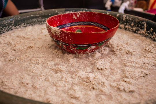 Traditional Mexican beverage called Tejate made of ground corn in a big pot.