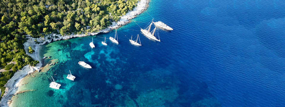 Aerial drone ultra wide photo of tropical Caribbean bay with white sand beach and beautiful turquoise and sapphire clear sea © aerial-drone