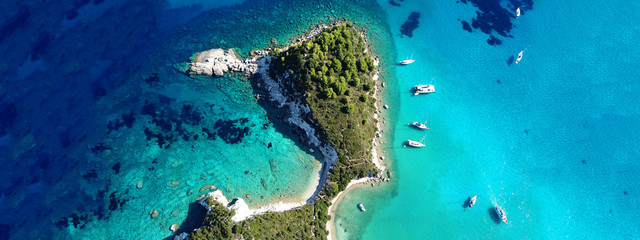Aerial drone ultra wide photo of tropical Caribbean bay with white sand beach and beautiful turquoise and sapphire clear sea
