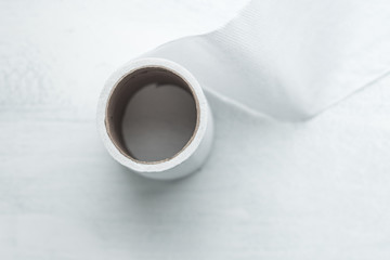 Toilet Paper on a Rustic Board Painted with White Background