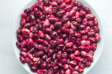 Red Beans in a Bowl on a Rustic Board Painted with White Background