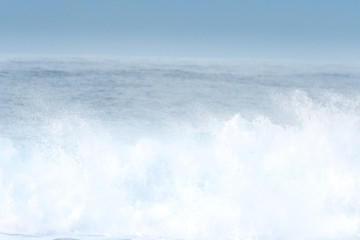 Surfer swallowed by a big wave on a beach on the north coast of Spain