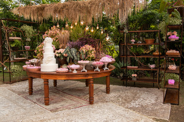 Wedding Setup. Cake table with sweet, decoration and flowers 