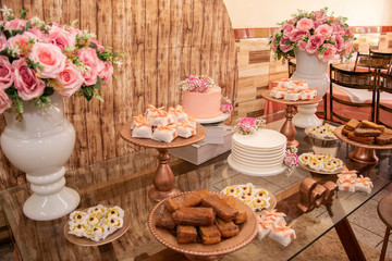 Wedding Setup. Cake table with sweet, decoration and flowers 