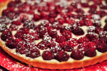 Raspberry tart on red plate