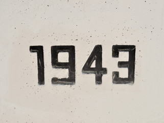 1943 Embossed on Concrete Wall