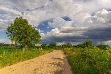 Fototapeta na wymiar Rural landscape with sky full of cumulonimbus clouds