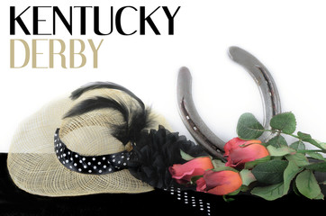 Kentucky Derby photo of a fascinator hot with red roses and a horseshoe. on a black table with...