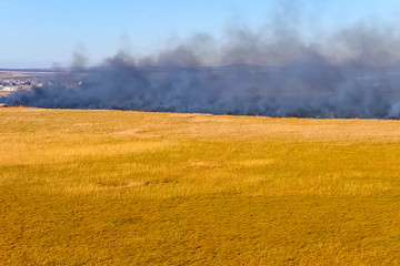 Steppe fire. Burning dry grass, fire smoke