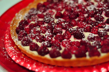 Raspberry tart on red plate