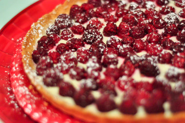 Raspberry tart on red plate